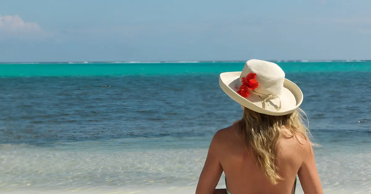 A girl wearing a hat observes the Caribbean Sea in Belize