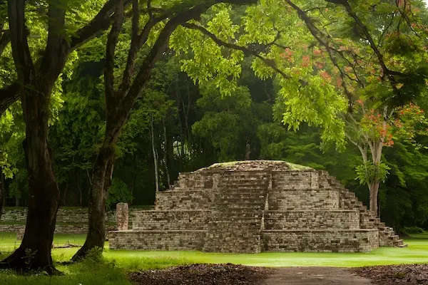The ancient stone pyramids and large grassy plazas of the Mayan ruins of Copan in Honduras.