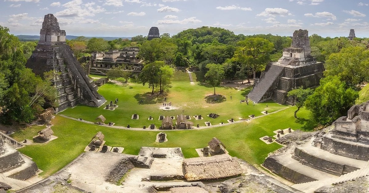 The great plaza of the Mayan City of Tikal and its temples raising above the jungle