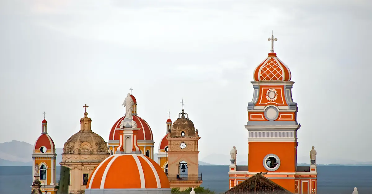 A view of the colonial bell churches in the city of Granada with lake Nicaragua in the background