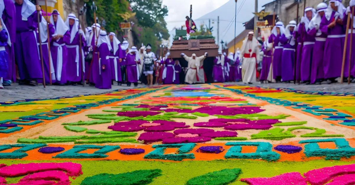 A procession walks above a sawdust carpet during Holy Week in Antigua