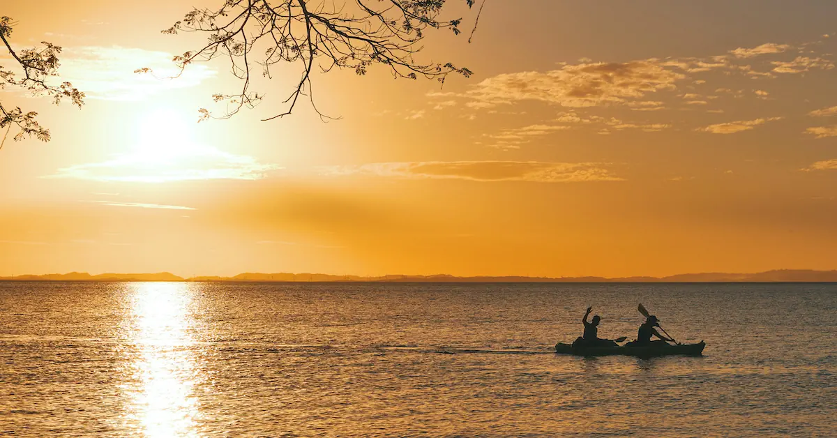 Two man are kayaking in Lake Managua next to Ometepe Island during the late afternoon