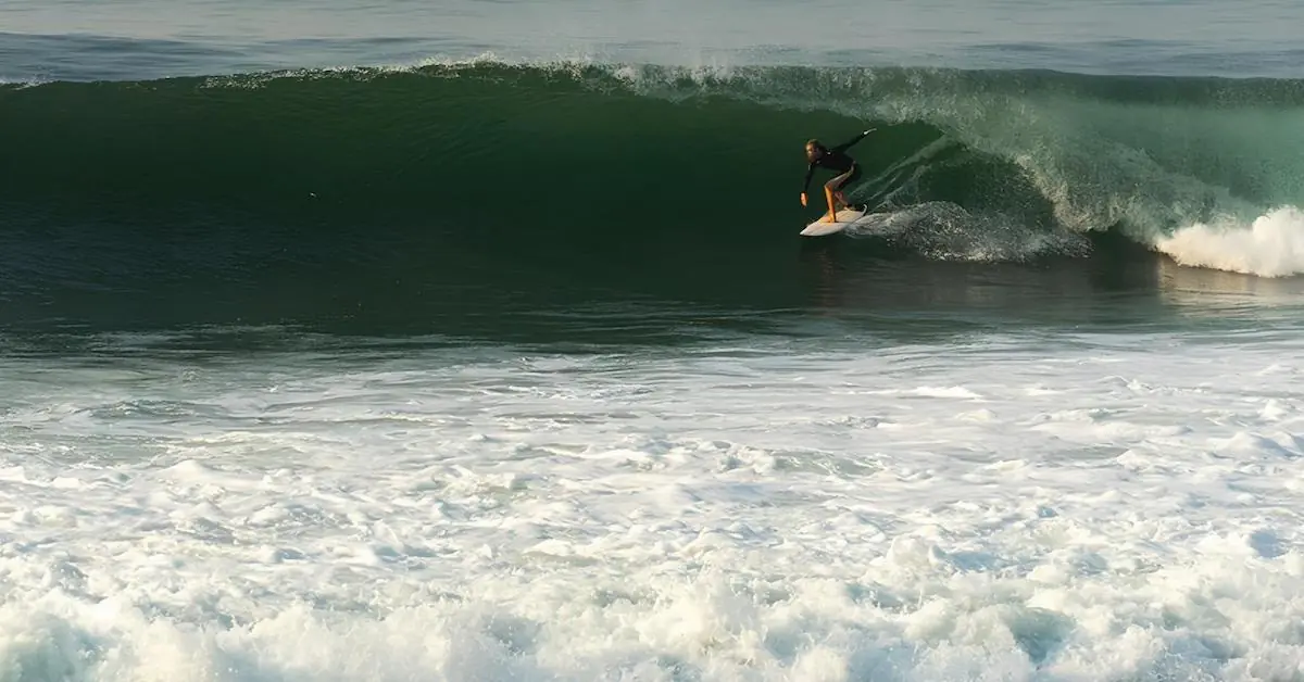 A man is surfing in a wave on the Pacific Ocean of El Salvador