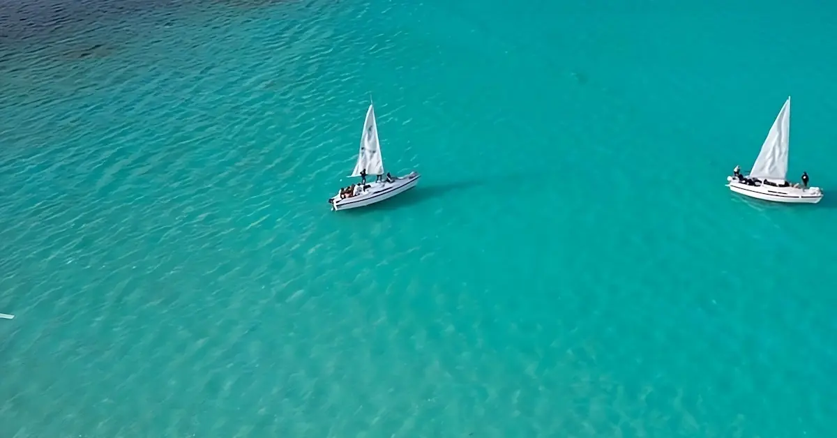 Two sailing boats are in the Bacalar Lagoon in Mexico